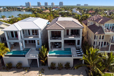Example of a transitional home design design in Miami