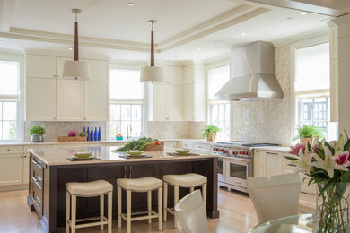 Large elegant light wood floor eat-in kitchen photo in DC Metro with a drop-in sink, recessed-panel cabinets, white cabinets, marble countertops, beige backsplash, mosaic tile backsplash, stainless steel appliances and an island