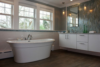 Example of a mid-sized beach style multicolored tile and glass tile porcelain tile freestanding bathtub design in Boston with flat-panel cabinets, white cabinets and green walls