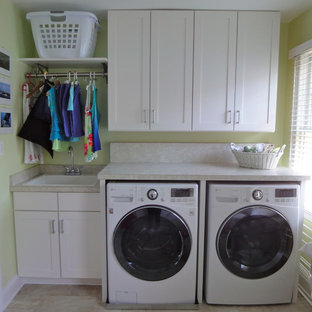 This is an example of a medium sized classic galley separated utility room in DC Metro with shaker cabinets, laminate countertops, ceramic flooring, a side by side washer and dryer, a built-in sink, white cabinets and green walls.