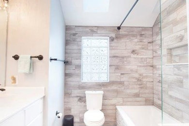 Mid-sized minimalist master black floor bathroom photo in Columbus with white cabinets