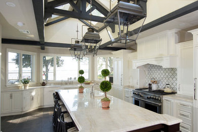 Eat-in kitchen - large traditional l-shaped dark wood floor and brown floor eat-in kitchen idea in Other with a farmhouse sink, raised-panel cabinets, white cabinets, quartz countertops, white backsplash, marble backsplash, paneled appliances and an island