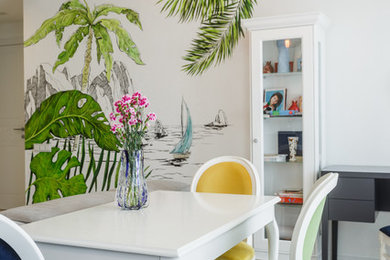 Mid-sized eclectic dining room in Saint Petersburg with white walls, medium hardwood floors, a standard fireplace, a plaster fireplace surround and beige floor.