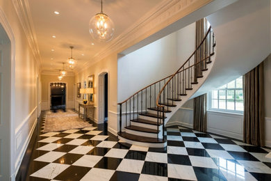 Inspiration for a huge timeless marble floor, black floor, coffered ceiling and wainscoting entryway remodel with a green front door