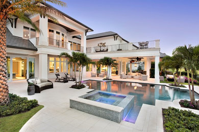 Example of a huge transitional backyard stone and custom-shaped lap hot tub design in Miami