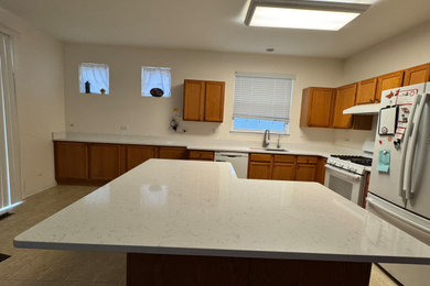 Example of a mid-sized transitional eat-in kitchen design in Chicago with quartz countertops and white countertops