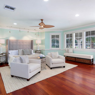 Inspiration for a mid-sized mediterranean master bedroom in Miami with green walls, medium hardwood floors, no fireplace and red floor.