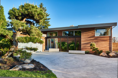 Large midcentury two-storey exterior in Seattle with wood siding.