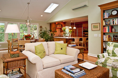 Inspiration for a large timeless open concept medium tone wood floor family room remodel in Nashville with green walls