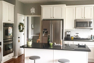 Mid-sized transitional light wood floor eat-in kitchen photo in Indianapolis with granite countertops, white backsplash, ceramic backsplash, stainless steel appliances and an island