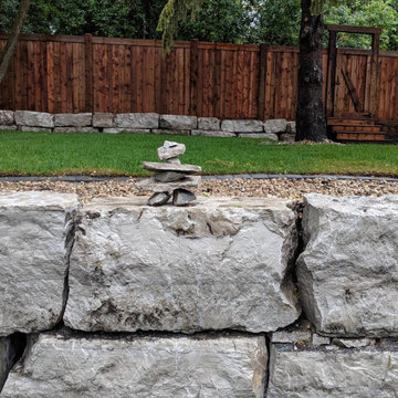 Natural boulder retaining wall in Edmonton