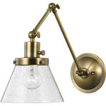 Progress Lighting - Hinton Collection Vintage Brass Swing Arm Wall Light - Enjoy focused task lighting with the industrial demeanor of this one-light swing arm wall bracket. A clear seeded glass shade is ready to provide you with focused task light wherever illumination is called upon. The light fixture's signature adjustable arm is coated in a vintage finish and makes this wall light a favorite choice for when you want to read your favorite novel before bed.
