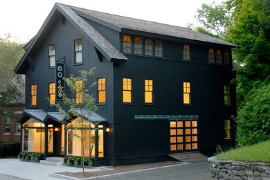 Example of a large transitional black three-story wood gable roof design in New York with a shingle roof