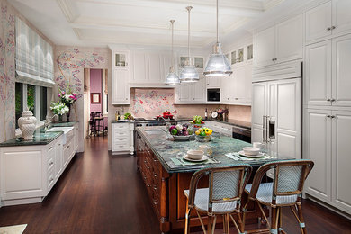 Inspiration for a large traditional u-shaped eat-in kitchen in Miami with a double-bowl sink, raised-panel cabinets, white cabinets, stainless steel appliances, dark hardwood floors, with island, quartzite benchtops, pink splashback, cement tile splashback and brown floor.