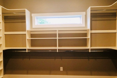 Inspiration for a large contemporary closet remodel in Other