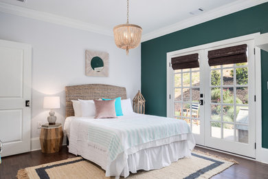 Beach style master bedroom in Atlanta with dark hardwood floors, brown floor and multi-coloured walls.