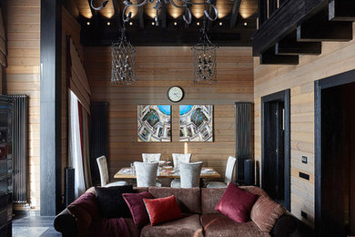 This is an example of a country open concept living room in Moscow with brown walls, dark hardwood floors and black floor.