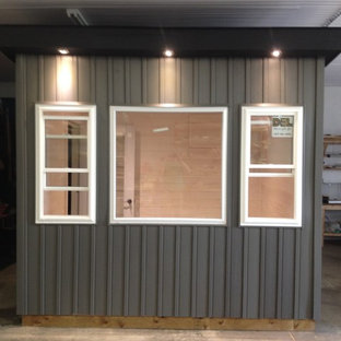 Inspiration for a small modern home studio in Toronto with white walls, laminate floors and a freestanding desk.