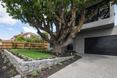 This is an example of a mid-sized contemporary home design in Melbourne.