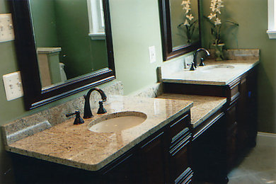 Bathroom - large master ceramic tile bathroom idea in Detroit with recessed-panel cabinets, dark wood cabinets, granite countertops and green walls