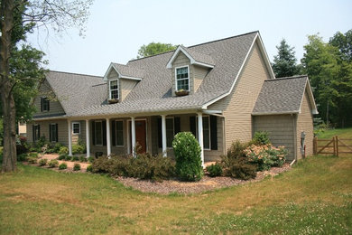 Mid-sized arts and crafts beige two-story exterior home photo in Philadelphia with a shingle roof