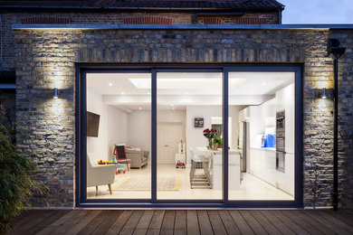Mid-sized contemporary three-storey brick exterior in London with a flat roof.