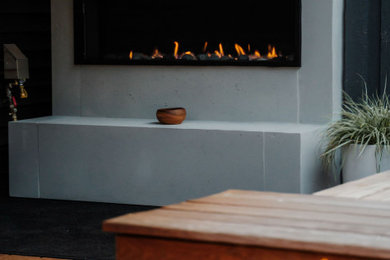 Deck - small backyard ground level deck idea in Vancouver with a fireplace and no cover