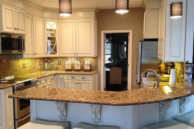 Kitchen - mid-sized transitional kitchen idea in DC Metro with an undermount sink, raised-panel cabinets, white cabinets, granite countertops, beige backsplash, stone slab backsplash, stainless steel appliances and a peninsula