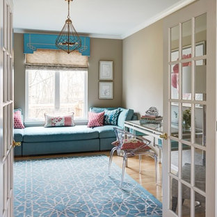 Inspiration for a medium sized modern study in Chicago with beige walls, light hardwood flooring, no fireplace and a freestanding desk.