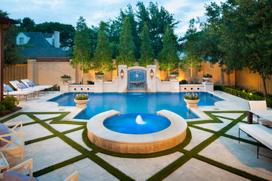 Photo of a traditional backyard custom-shaped pool in Dallas with a water feature and natural stone pavers.