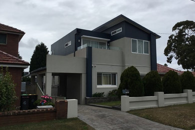 Design ideas for a contemporary two-storey house exterior in Adelaide with mixed siding.