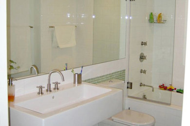 Example of a small kids' mosaic tile floor tub/shower combo design in New York with a wall-mount sink, laminate countertops, an undermount tub and white walls