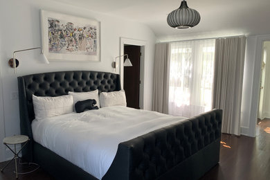 Example of a mid-sized transitional master dark wood floor, brown floor and vaulted ceiling bedroom design in Los Angeles with white walls
