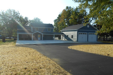Inspiration for a large timeless blue mixed siding exterior home remodel in Indianapolis with a shingle roof