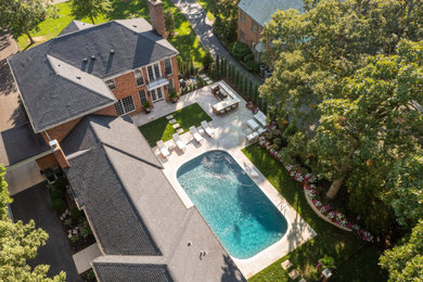 Large elegant backyard concrete paver pool photo in St Louis