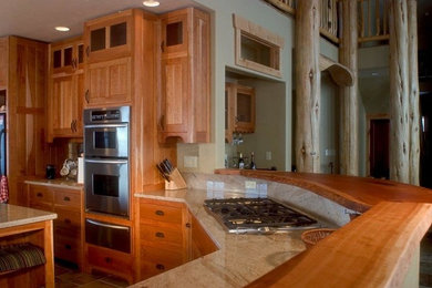 デンバーにある広いトラディショナルスタイルのおしゃれなキッチン (スレートの床、シェーカースタイル扉のキャビネット、中間色木目調キャビネット、木材カウンター、シルバーの調理設備、ベージュキッチンパネル、セラミックタイルのキッチンパネル) の写真