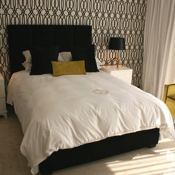 Guest bedroom,black tufted headboard,white linen,yellow ottoman