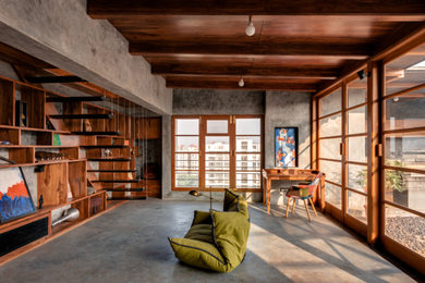 This is an example of a mid-sized industrial family room in Pune.