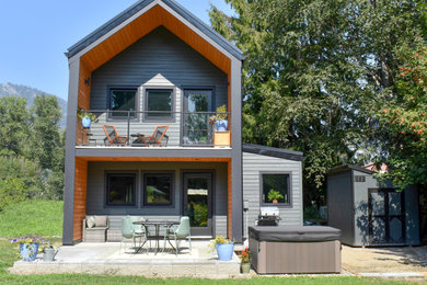 Small modern gray vinyl and clapboard exterior home idea in Vancouver