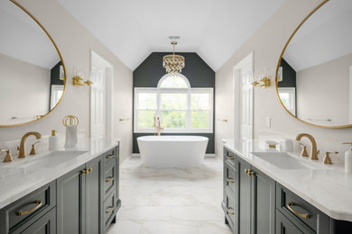 Inspiration for a large transitional master white tile and porcelain tile porcelain tile, white floor, double-sink and vaulted ceiling bathroom remodel in Detroit with recessed-panel cabinets, green cabinets, a two-piece toilet, beige walls, an undermount sink, quartz countertops, a hinged shower door, white countertops and a built-in vanity
