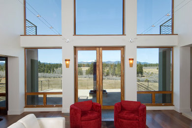 Example of a large trendy formal and open concept dark wood floor living room design in Portland with white walls, no fireplace and no tv