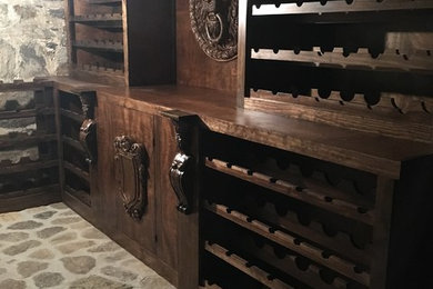 Design ideas for a large midcentury wine cellar in Other with concrete flooring, storage racks and grey floors.