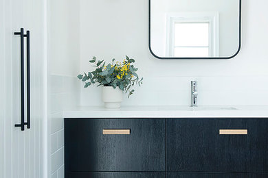 This is an example of a large contemporary kids bathroom in Perth with black cabinets, a drop-in tub, an open shower, white tile, ceramic tile, white walls, ceramic floors, an undermount sink, engineered quartz benchtops and an open shower.