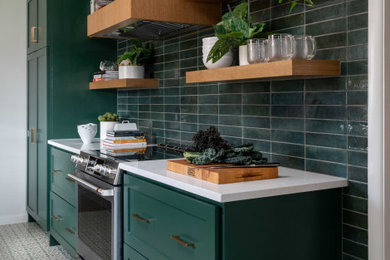 Example of a transitional kitchen design in Dallas with green cabinets and green backsplash