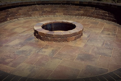 Inspiration for a backyard concrete paver landscaping in Minneapolis with a fire pit.