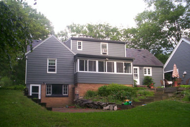 Mid-sized country three-storey grey exterior in Cleveland with wood siding and a gable roof.