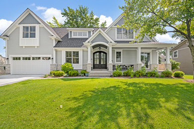 Farmhouse gray two-story concrete exterior home photo in Chicago with a shingle roof
