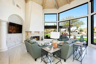 Example of a large transitional open concept porcelain tile and gray floor living room design in Phoenix with white walls, a standard fireplace, a tile fireplace and a wall-mounted tv