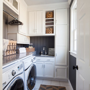 Inspiration for a small traditional l-shaped separated utility room in New York with a submerged sink, recessed-panel cabinets, white cabinets, granite worktops, ceramic flooring, a side by side washer and dryer and black walls.