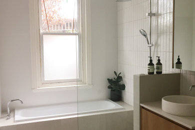 This is an example of a small eclectic wet room bathroom with a drop-in tub, white tile, porcelain floors, a vessel sink, engineered quartz benchtops, grey floor, an open shower, a single vanity and a floating vanity.